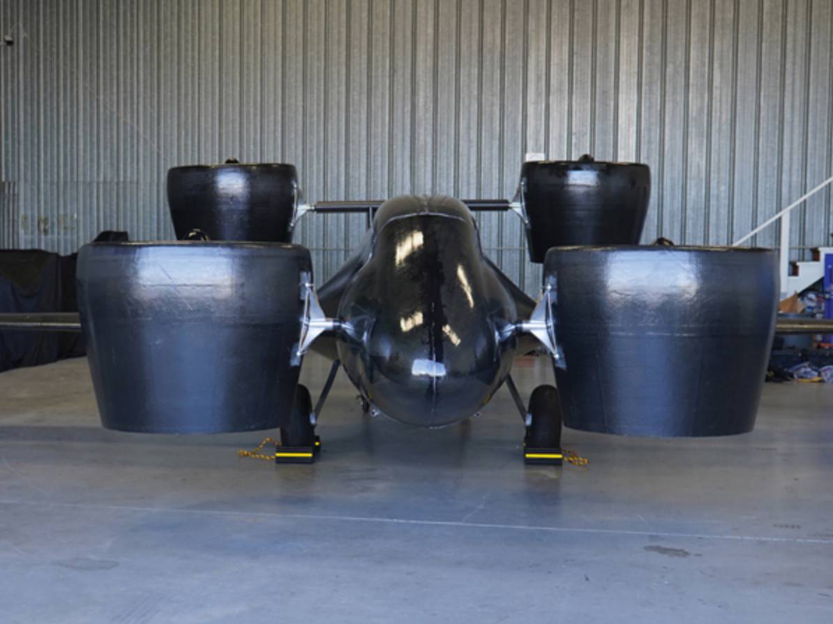 Sabrewing Rhaegal cargo aircraft prototype with four ducted fans inside a hangar.