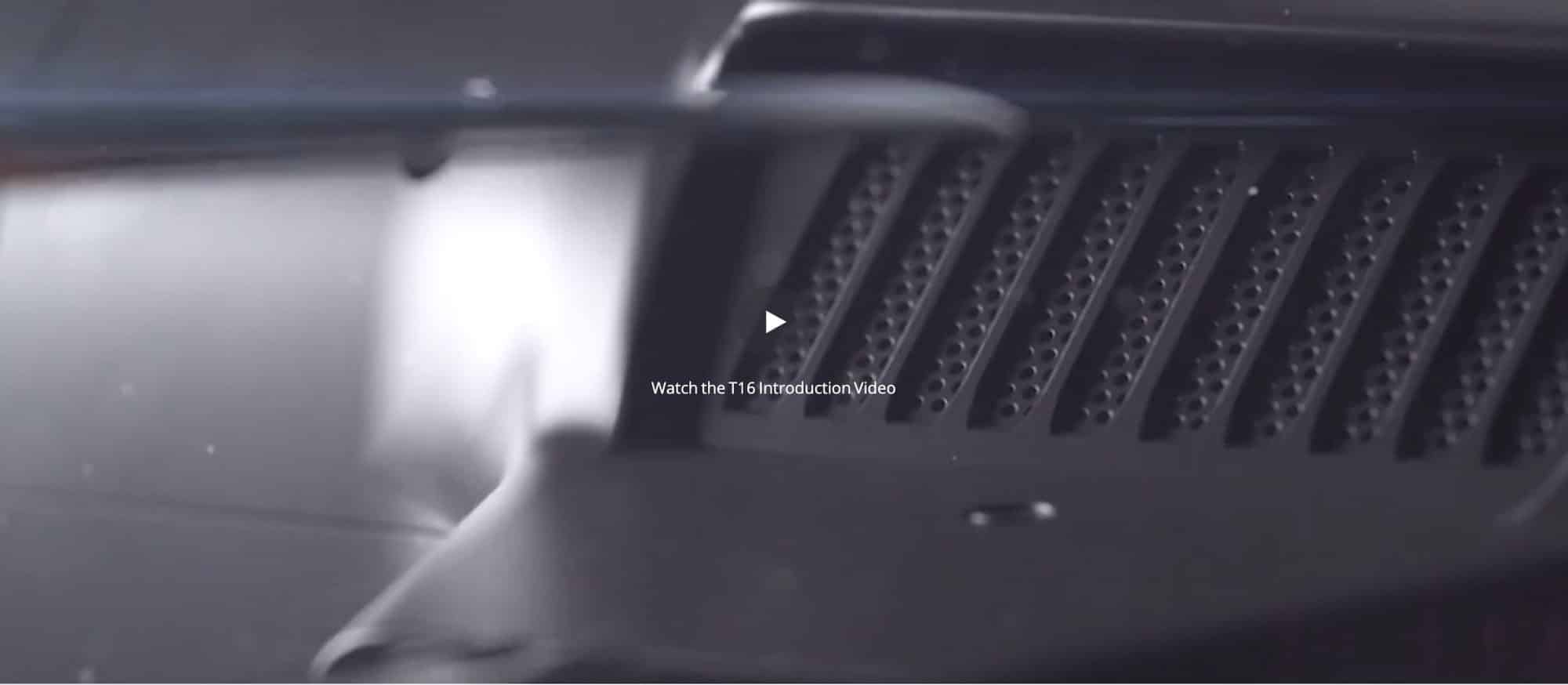 Dark video still of a DJI Agras T16 body panel with a play button overlay.