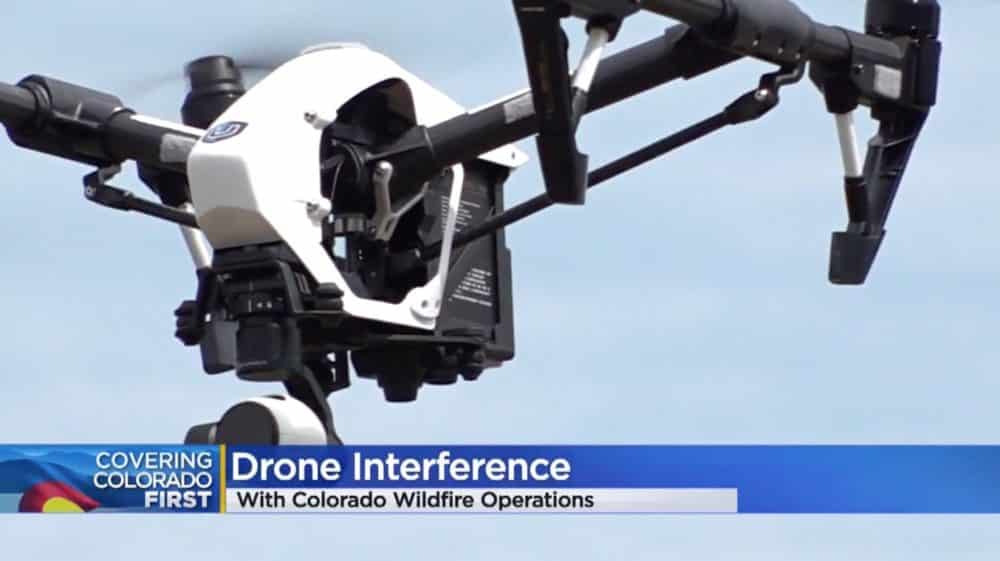 Colorado news broadcast graphic reading drone interference over a white DJI Inspire in flight.