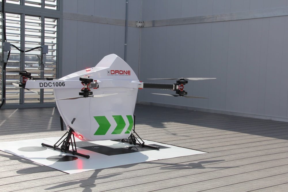 Drone Delivery Canada Sparrow aircraft DDC1006 resting on an indoor landing pad.