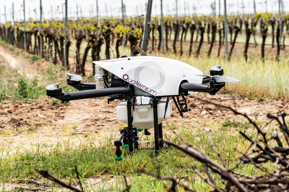 Quaternium HYBRiX agricultural drone spraying crops through its four nozzles.