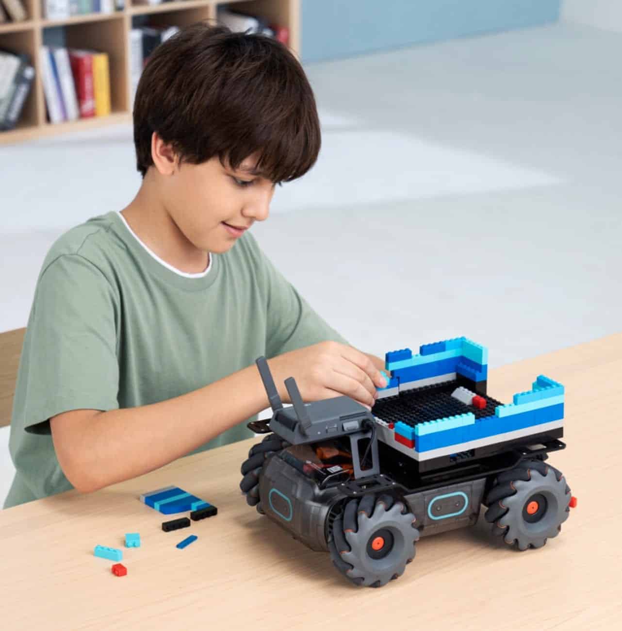 DJI RoboMaster EP Core educational robot with robotic arm and gripper.