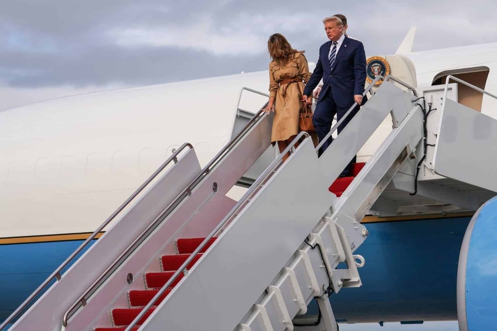 President Trump and the first lady walk down the airstairs of Air Force One.