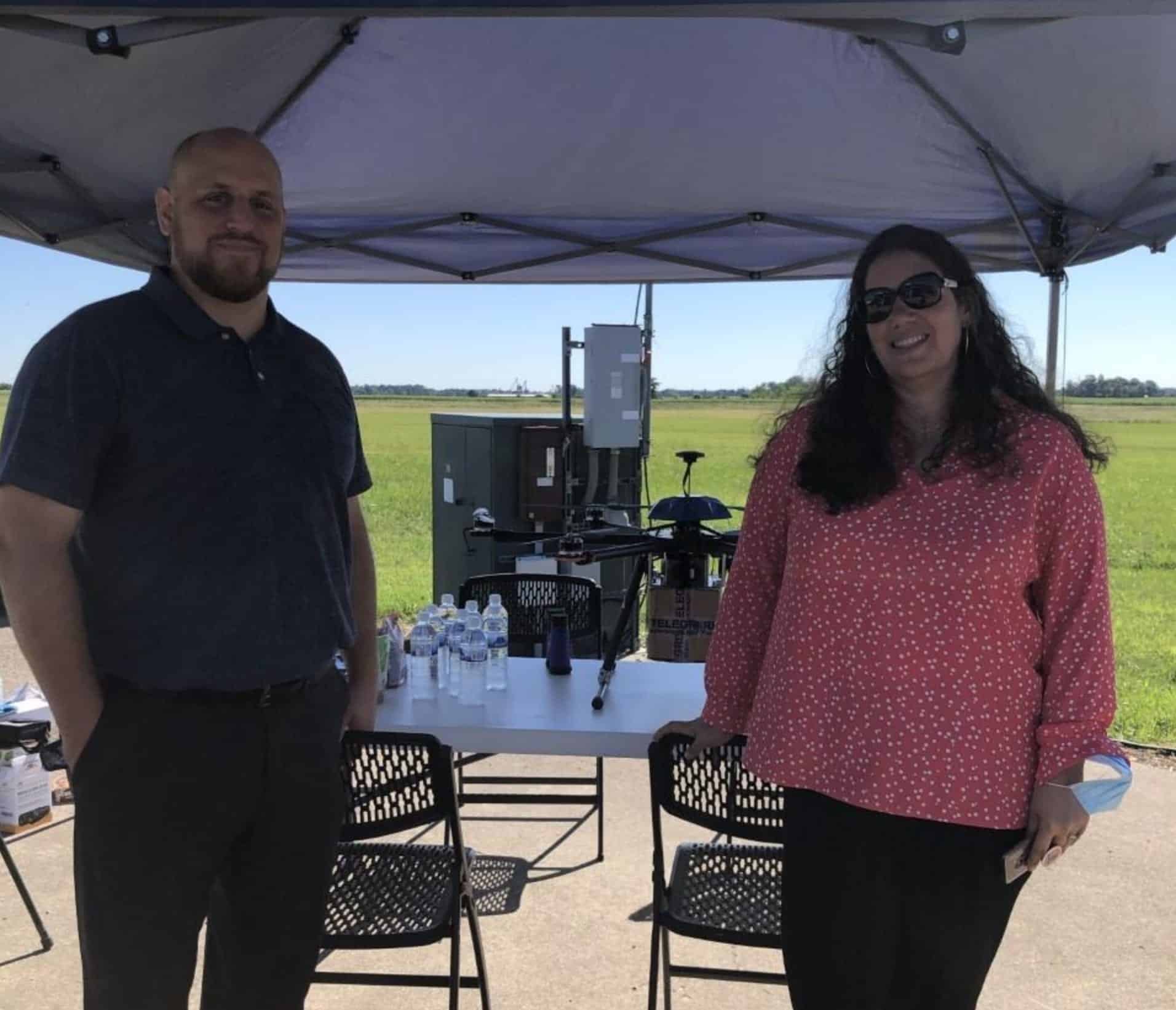 Mitch Heaton and Beth Flippo stand beside a delivery drone at Springfield Airport.