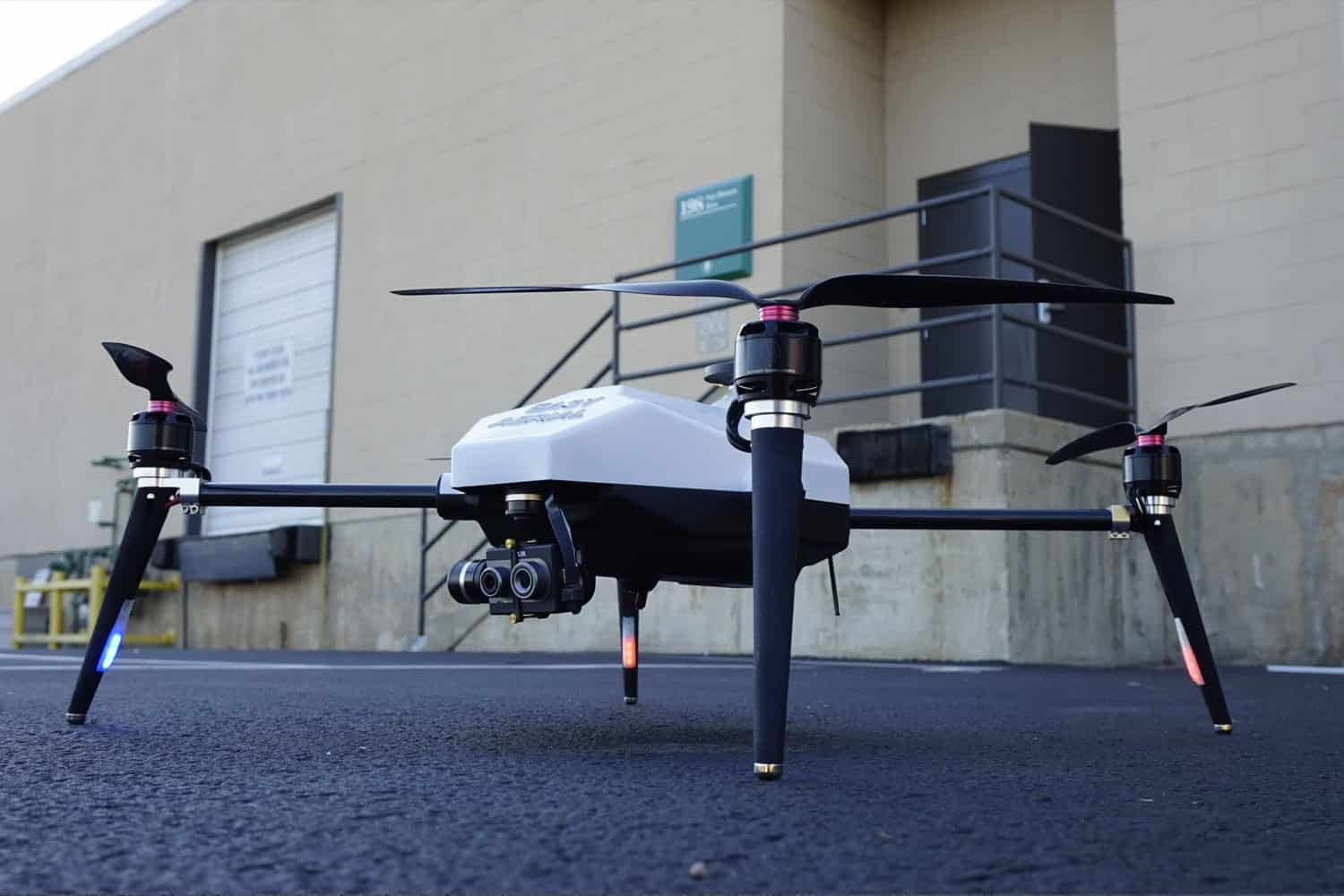Easy Aerial drone standing outside an industrial building with its sensor pod forward.