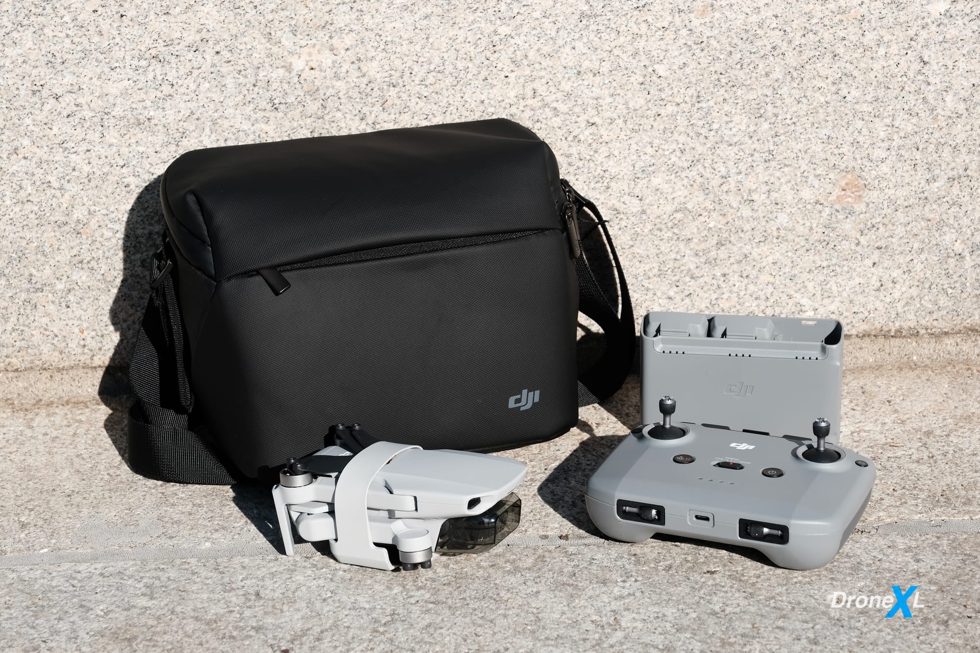 The DJI Mini 2 Fly More Combo with three batteries, charger, shoulder bag and spare props.