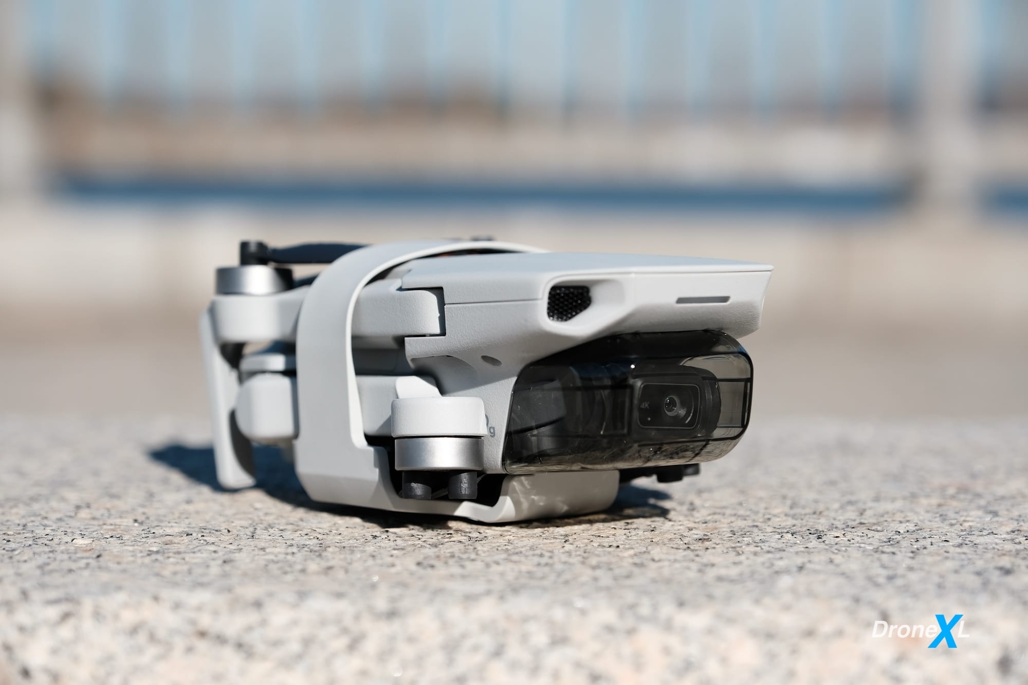 Folded DJI Mini 2 held closed by the included strap that protects the props.