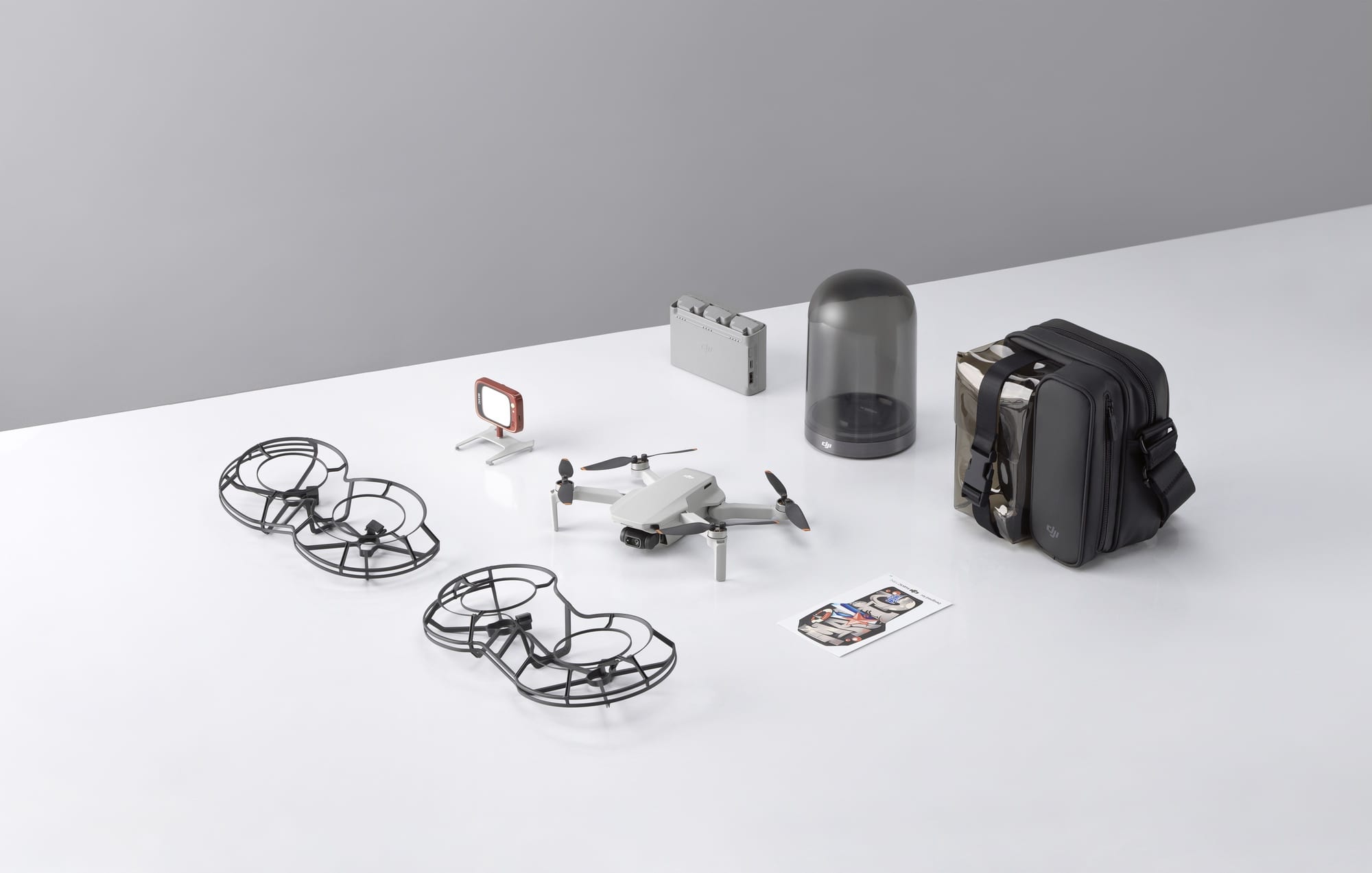 Mini 2 accessories including propeller guards, charging display case and carrying bag.