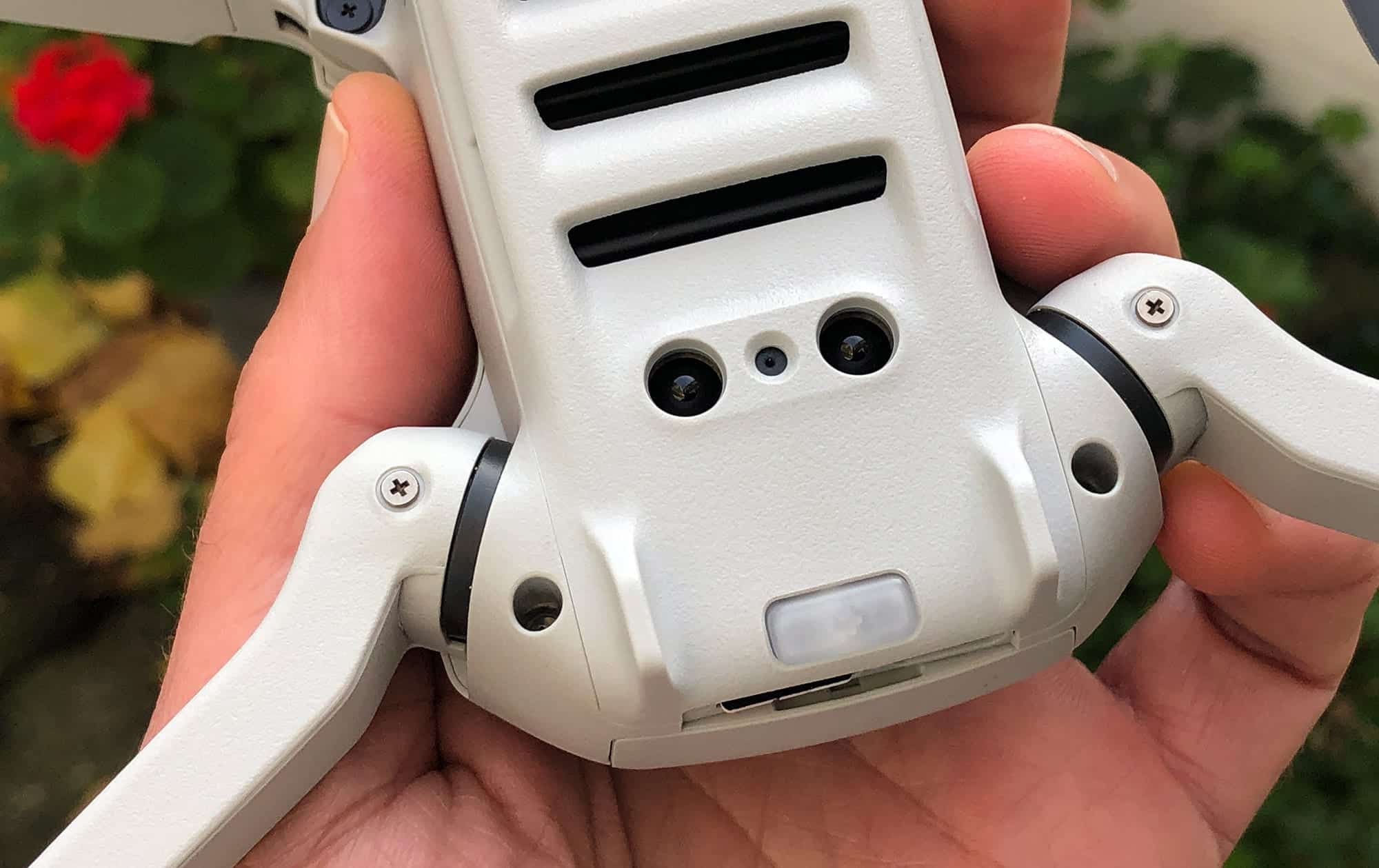 Bottom of the DJI Mini 2 showing Vision Positioning System sensors and rear status LED.