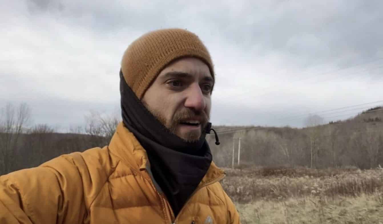 New York drone pilot Brian James speaking outdoors during the winter search.