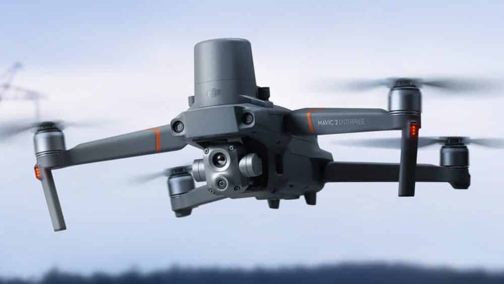DJI Mavic 2 Enterprise Advanced in flight with its thermal gimbal and beacon.