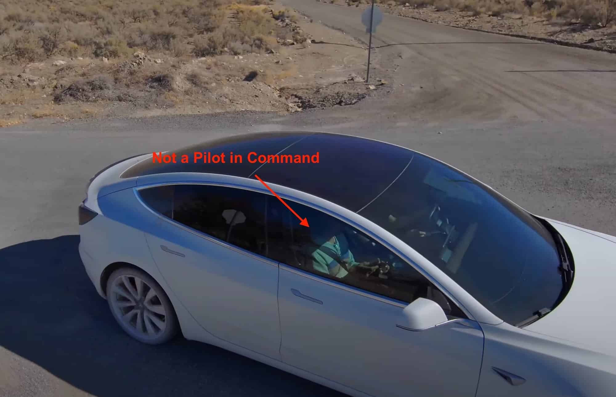 Annotated frame of a white Tesla driving itself along a desert road.