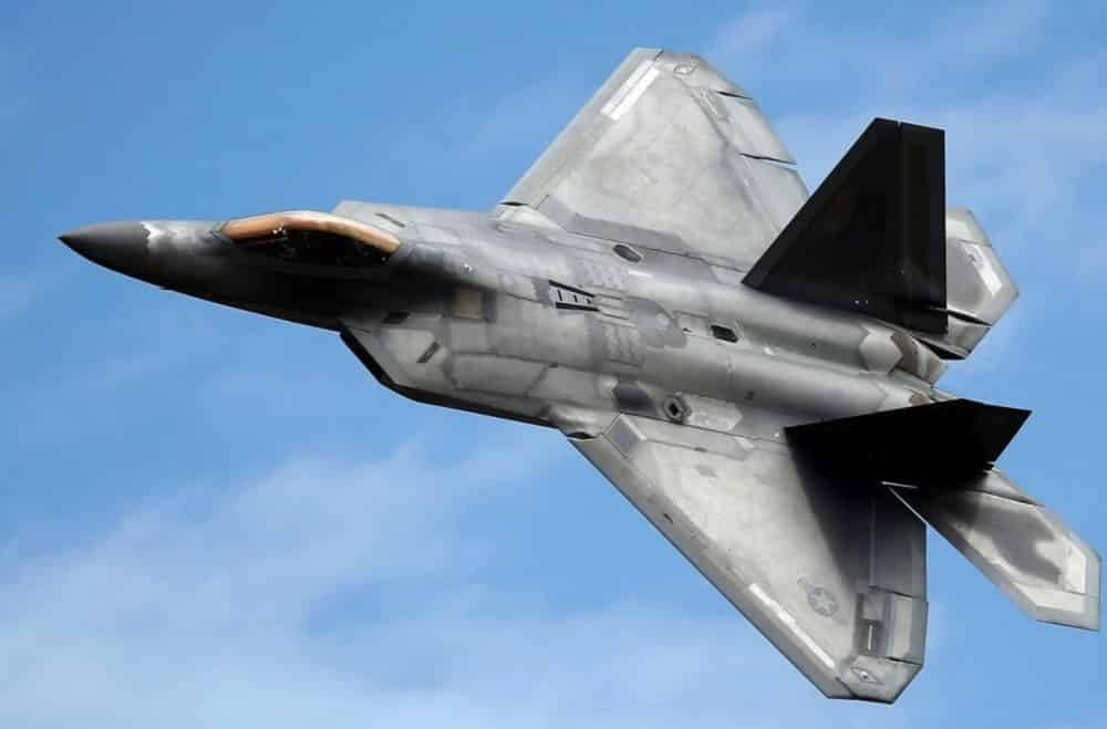 Valkyrie drone flying alongside U.S. Air Force F-22 and F-35 stealth fighter jets.