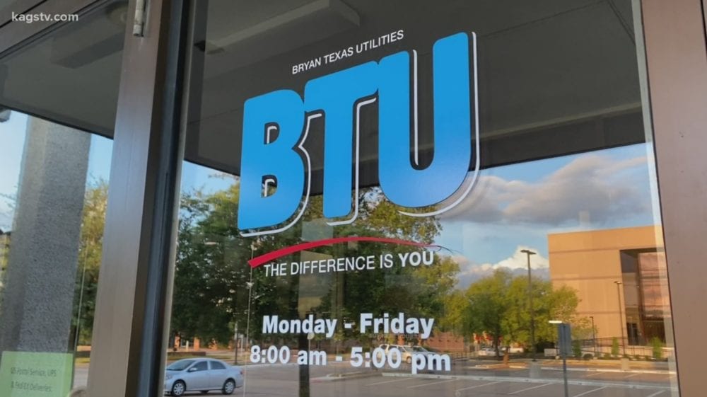 Bryan Texas Utilities logo and office hours on the glass door of its building.