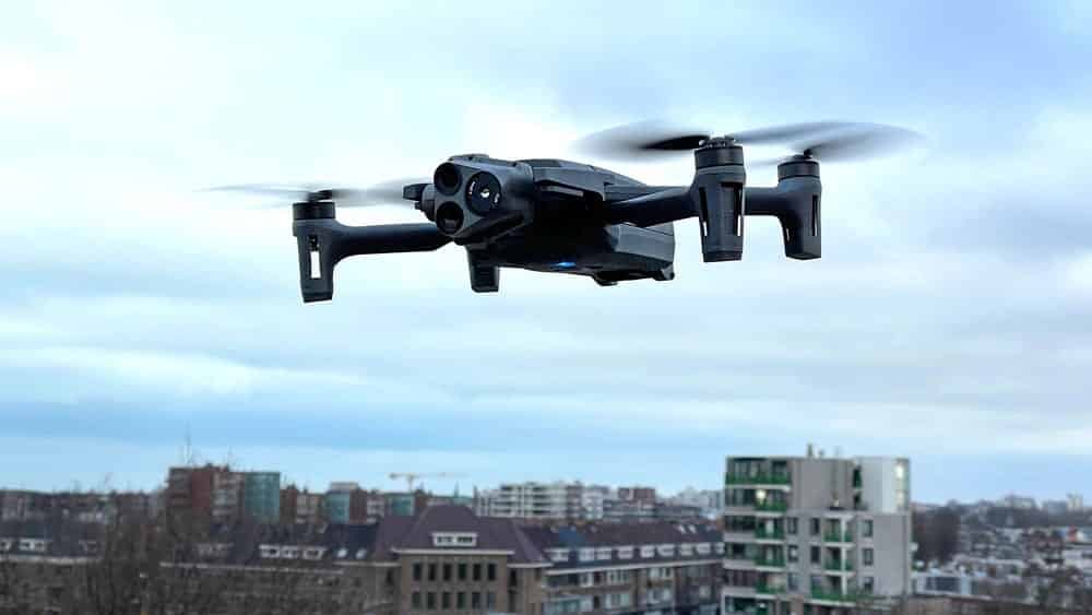 Black Parrot ANAFI USA drone flies above a European city skyline.