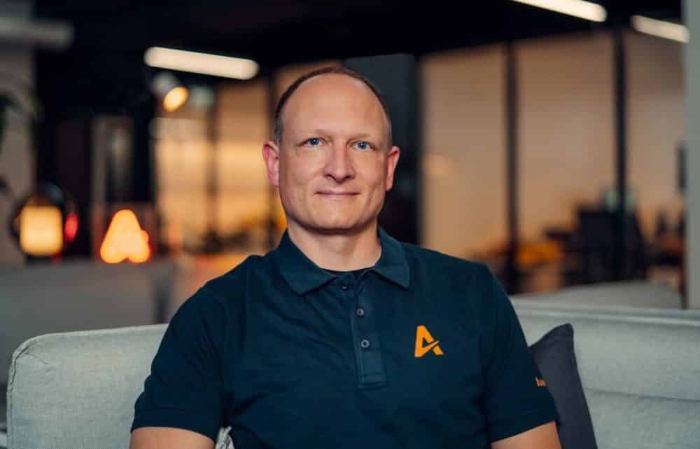 Portrait of a man wearing a dark polo shirt with the orange Auterion logo.