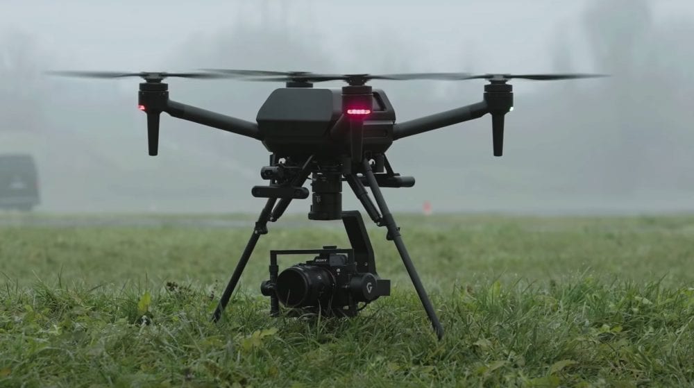 Sony Airpeak quadcopter sits on misty grass with a gimbal-mounted mirrorless camera.