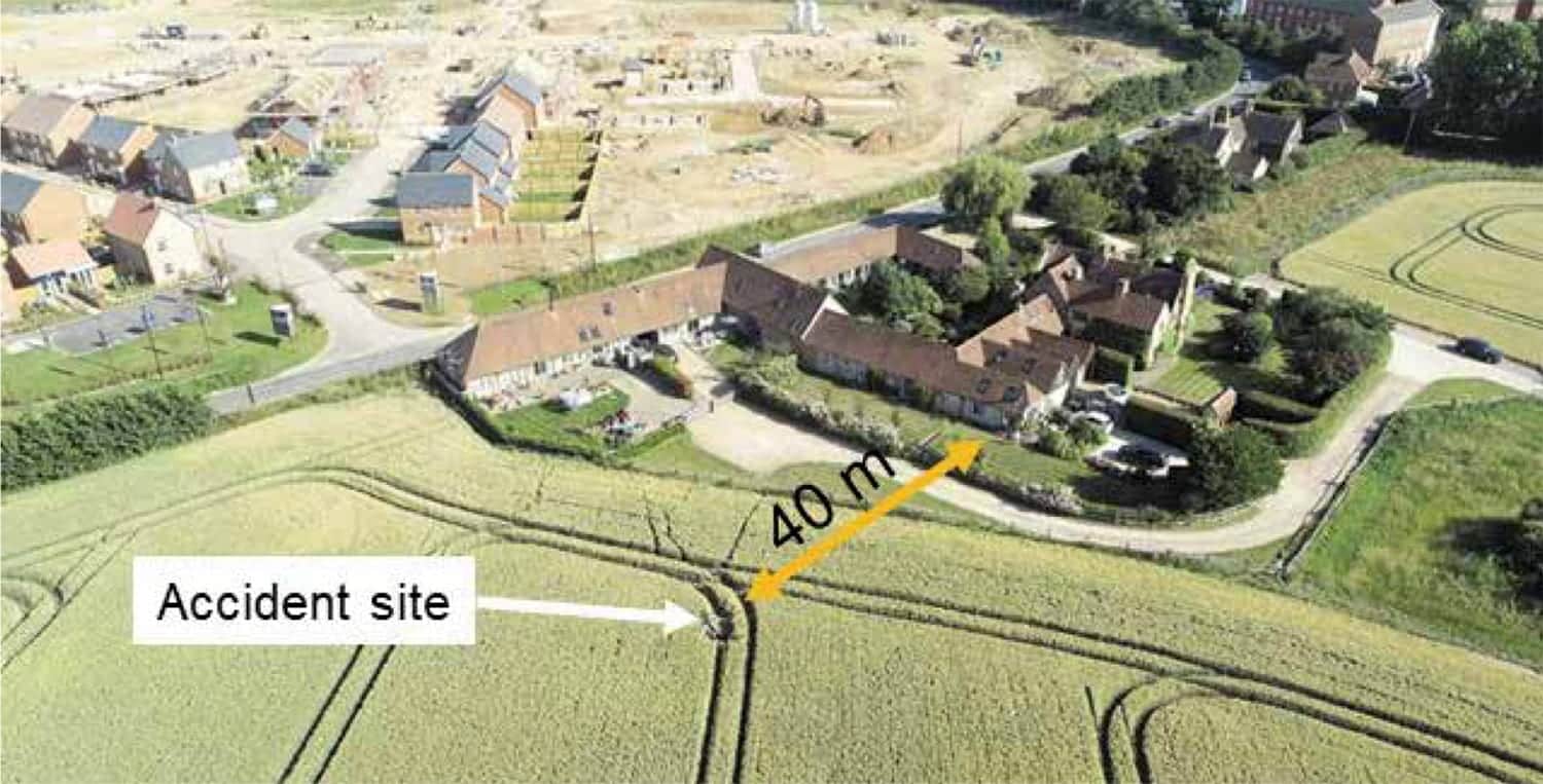 AAIB photo of the Airspeeder crash site in a field beside inhabited houses.