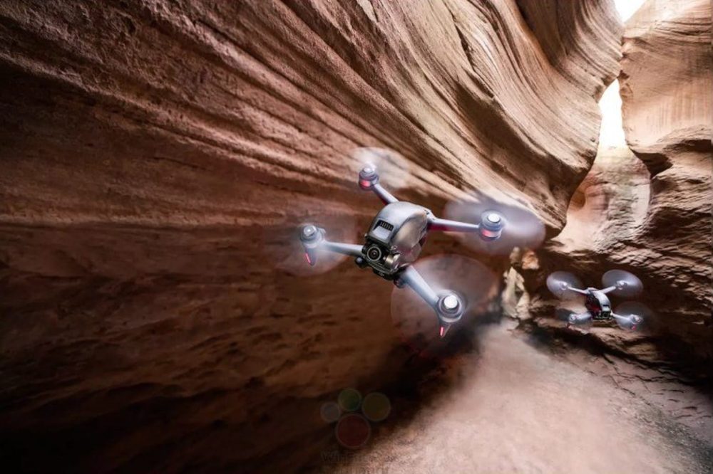 DJI FPV drone races through a narrow red sandstone slot canyon.