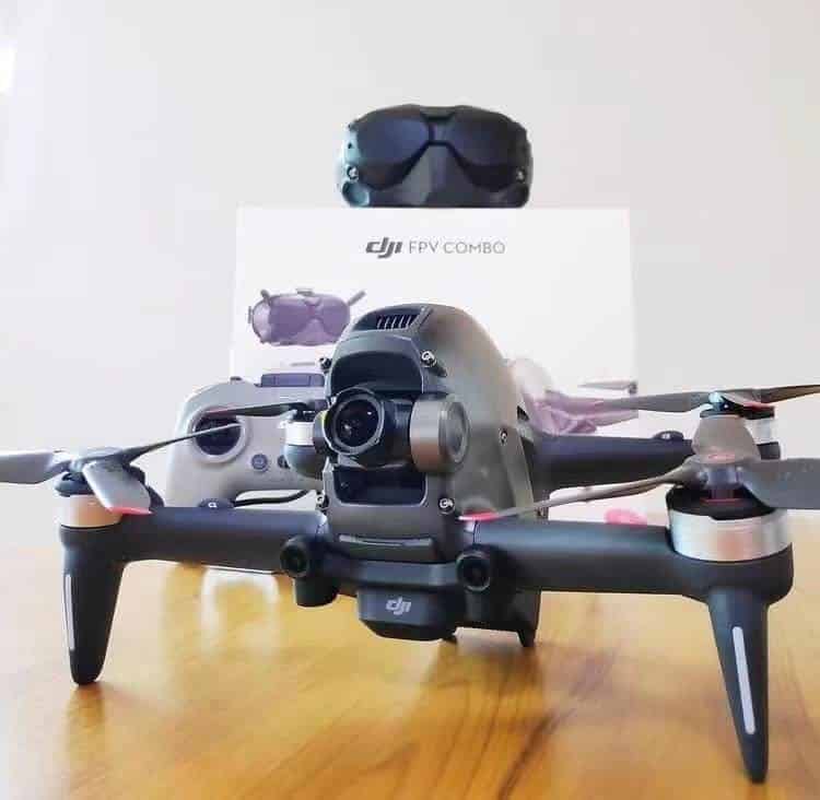 Leaked shot of the DJI FPV drone on a desk beside its box and Goggles V2.