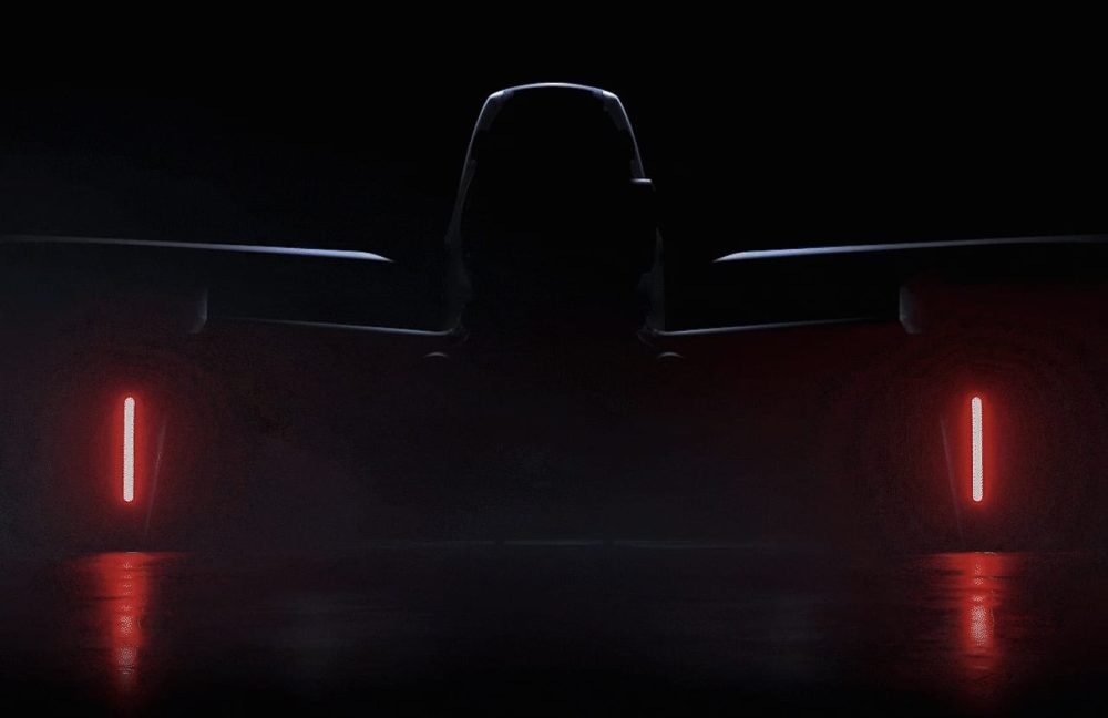 Dark teaser image showing the silhouette of a DJI FPV drone between two red lights.