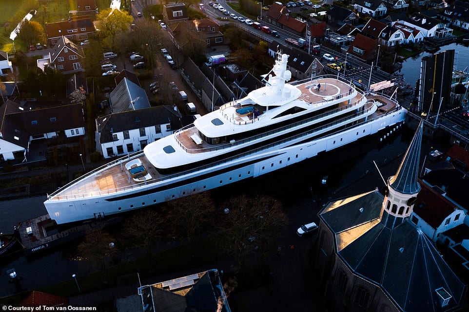 The superyacht Viva easing through a narrow Dutch canal on its way to the North Sea.