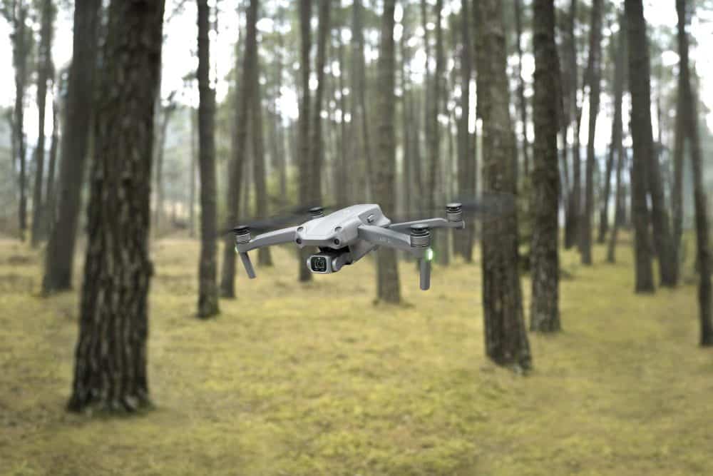 DJI press photo of the Air 2S banking above open landscape.