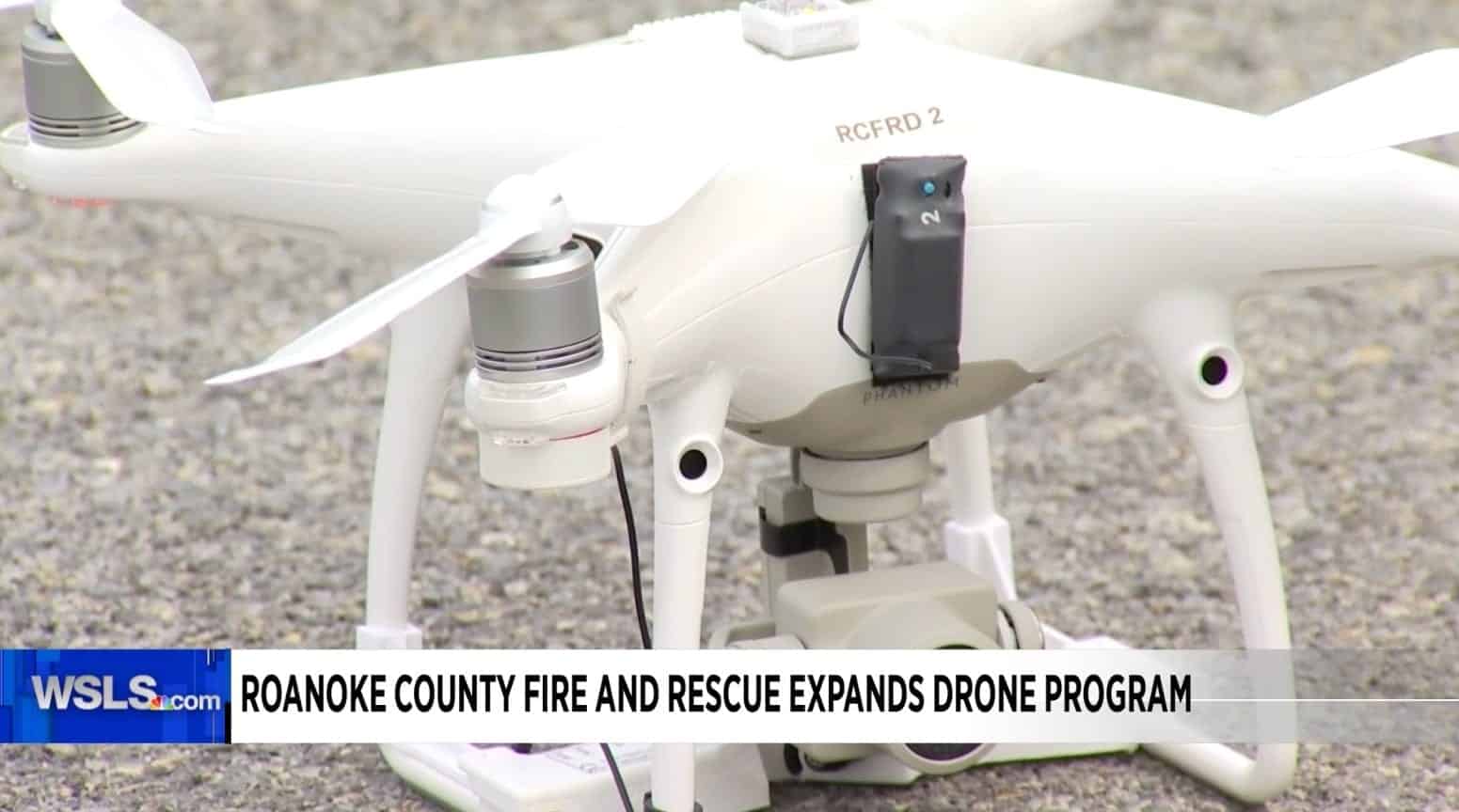 A white DJI Phantom marked RCFRD 2 fitted with a payload release device.