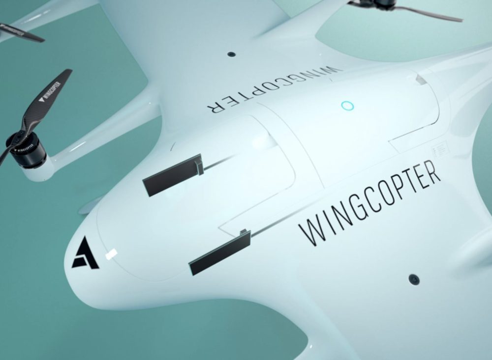 Close-up of a Wingcopter fuselage showing its tilting rotor and brand lettering.