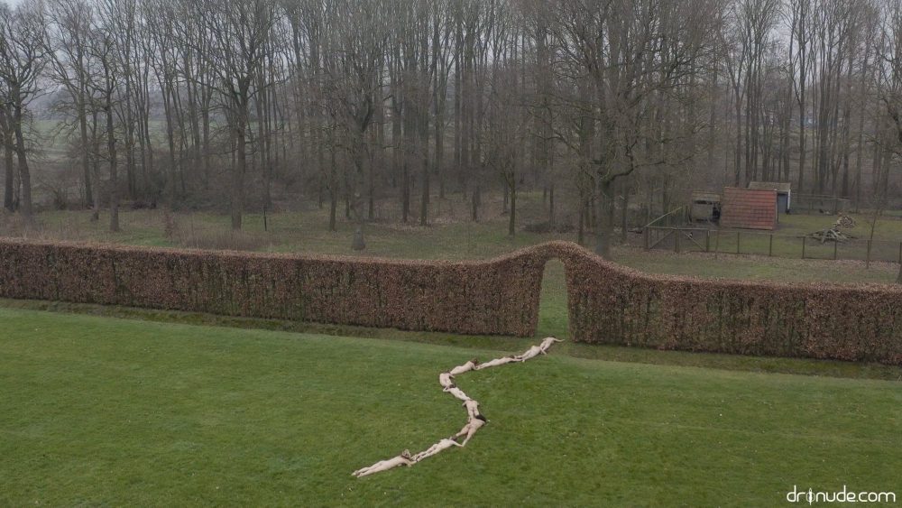 Overhead Dronude photograph of models arranged in a natural landscape setting.