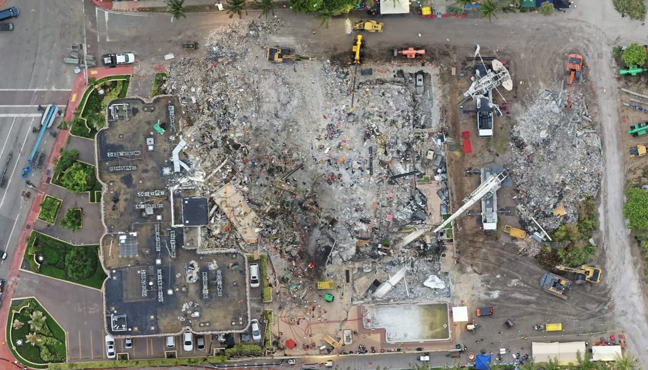 Aerial orthomosaic of the Surfside condominium collapse debris field with cranes working.