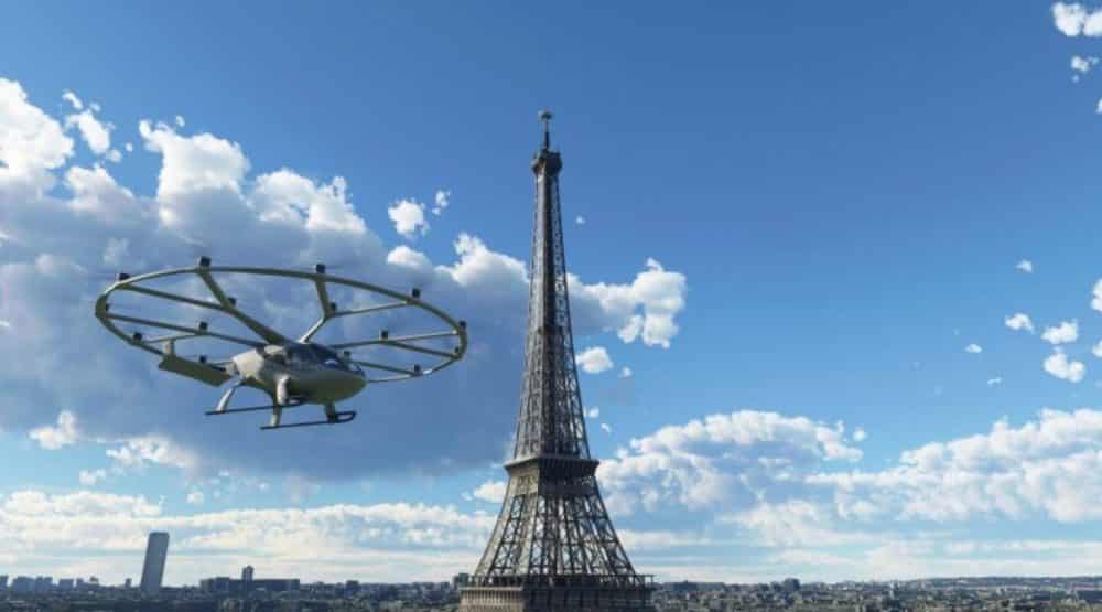 Volocopter air taxi flies past the Eiffel Tower in a simulator scene.