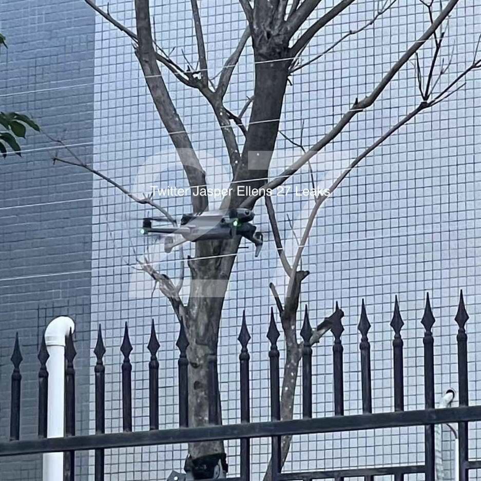 Wider leaked frame showing the Mavic 3 near a tree above an iron fence.