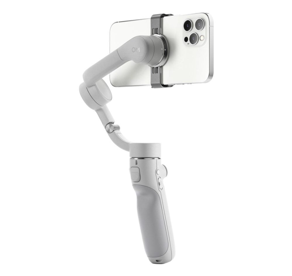 The DJI OM 5 holding a smartphone on its included screw-on tripod.
