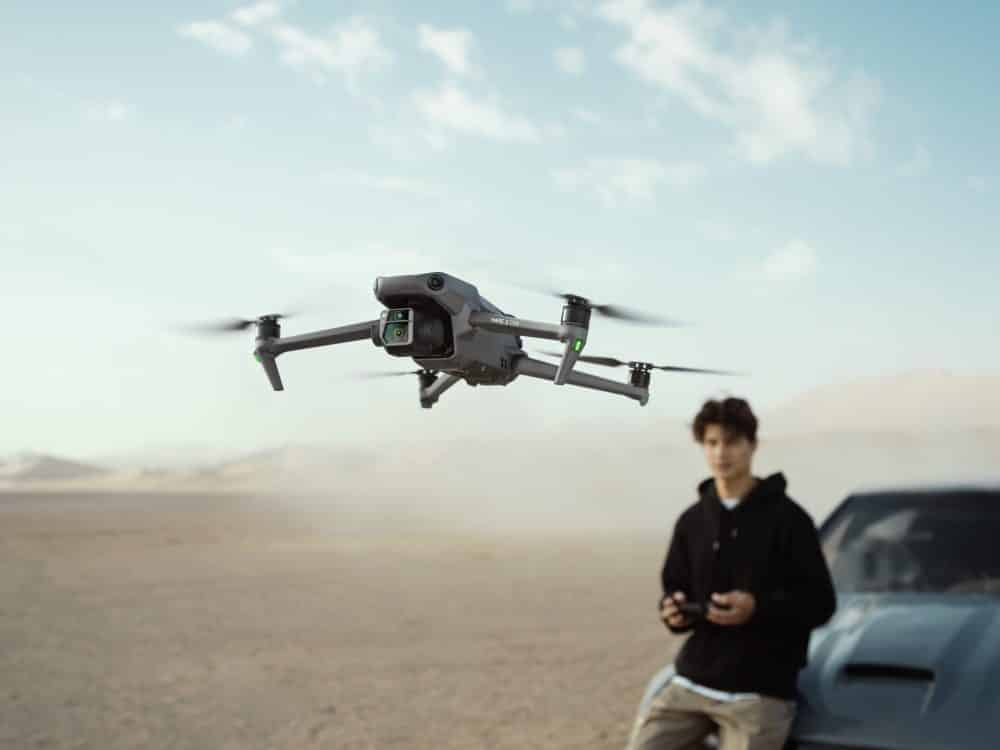 DJI Mavic 3 following a car sliding through a turn.