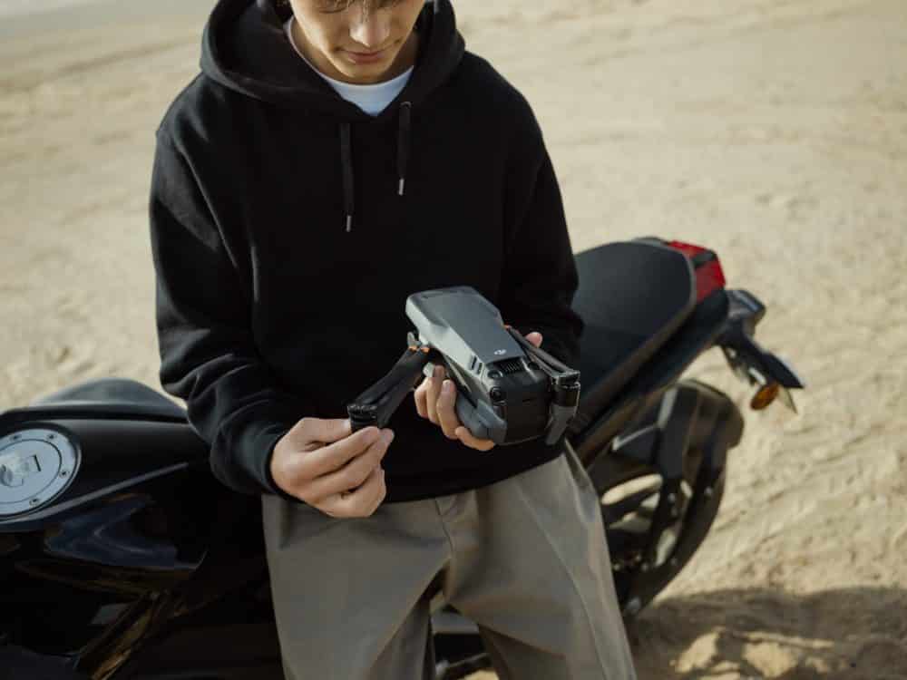 The Mavic 3 tracking a car mid-drift in DJI promotional photography.