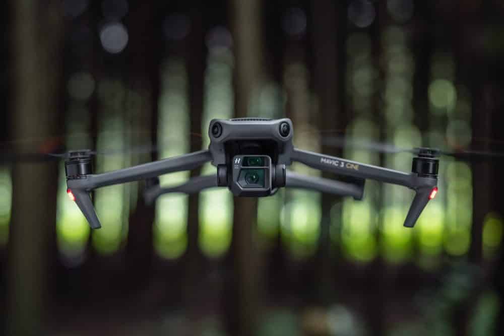 DJI Mavic 3 flying in forest, where its omnidirectional sensors dodge trees and branches.