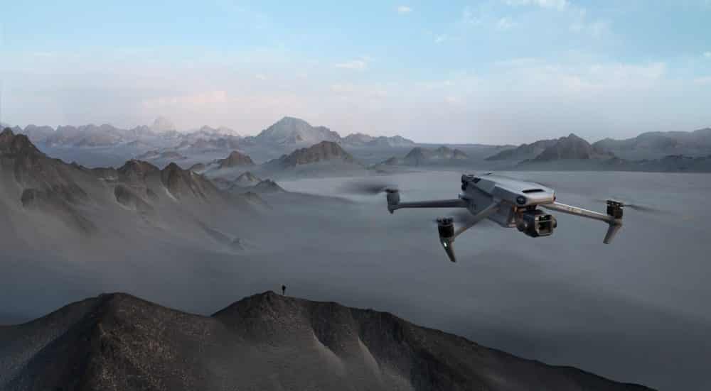 Front-facing DJI Mavic 3 key visual with mountains behind the drone.