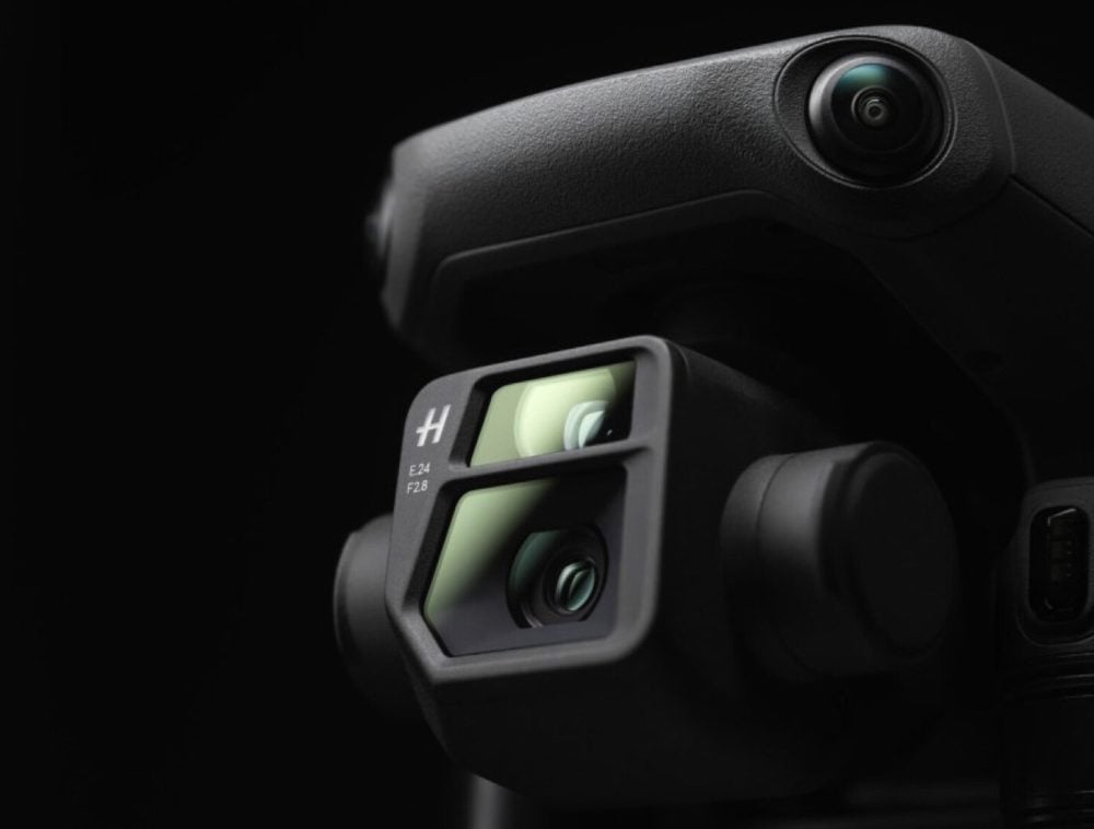 Close-up of the Mavic 3 Hasselblad camera and tele lens on black.