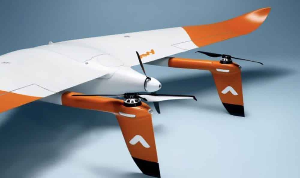 White and orange Avy Aera fixed-wing VTOL drone shown in a product render.