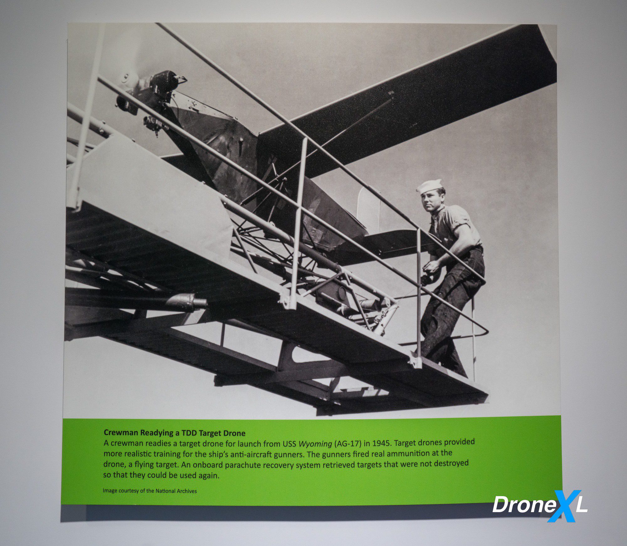Archival image of a crewman readying a TDD target drone aboard USS Wyoming in 1945.