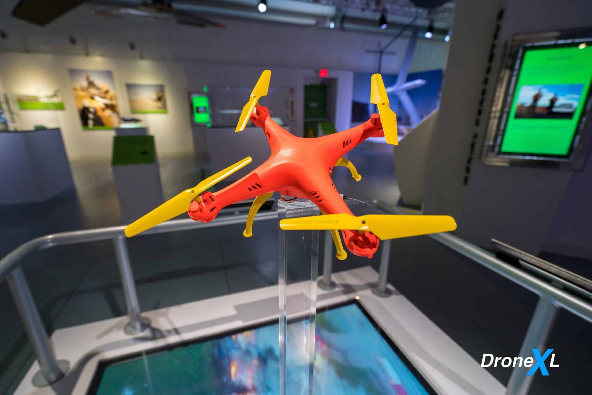 Exhibit text on drones inspecting bridges and oil rigs too risky for piloted aircraft.