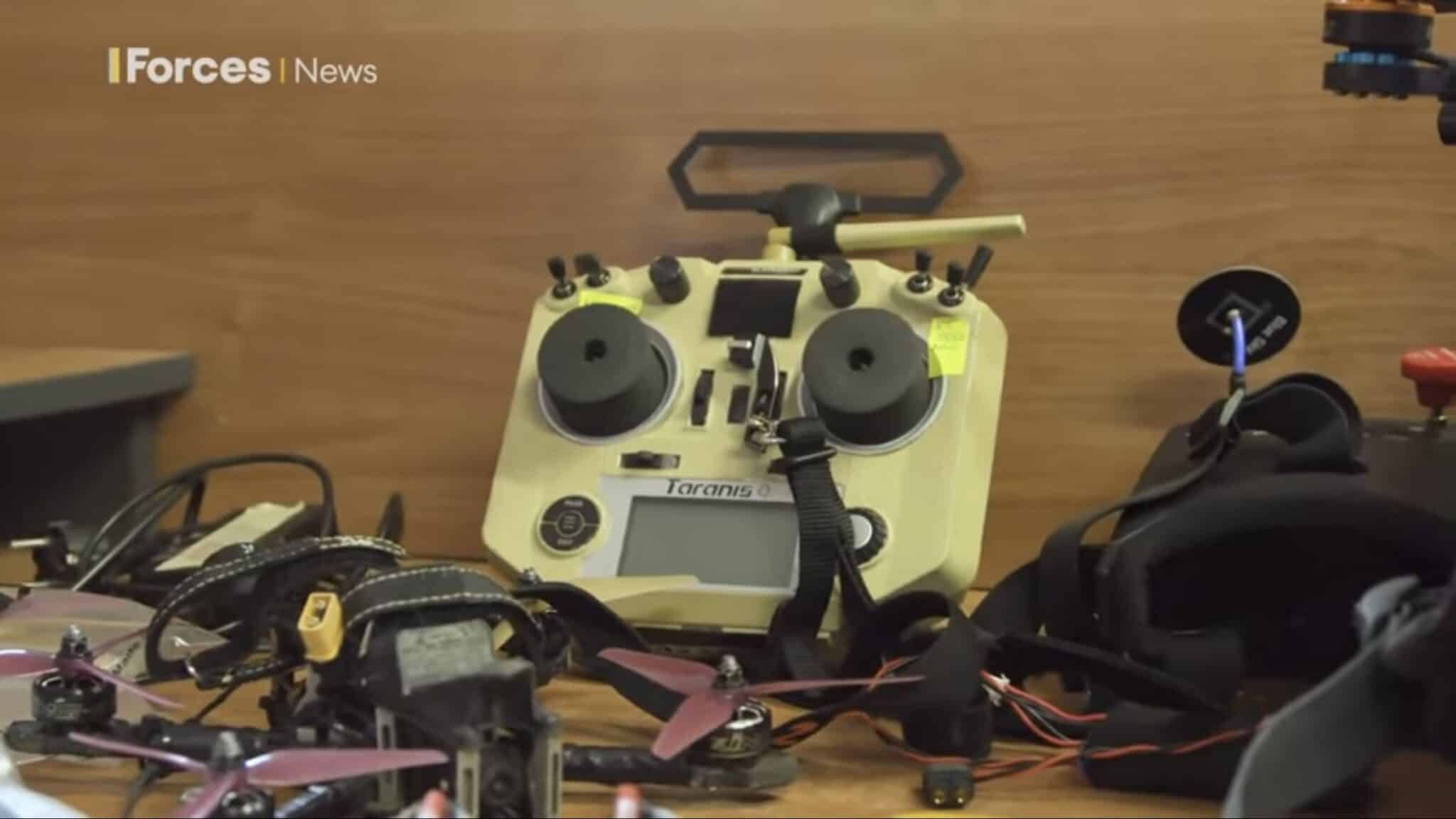 Workbench of drone parts, batteries and hacked thermal camera modules.