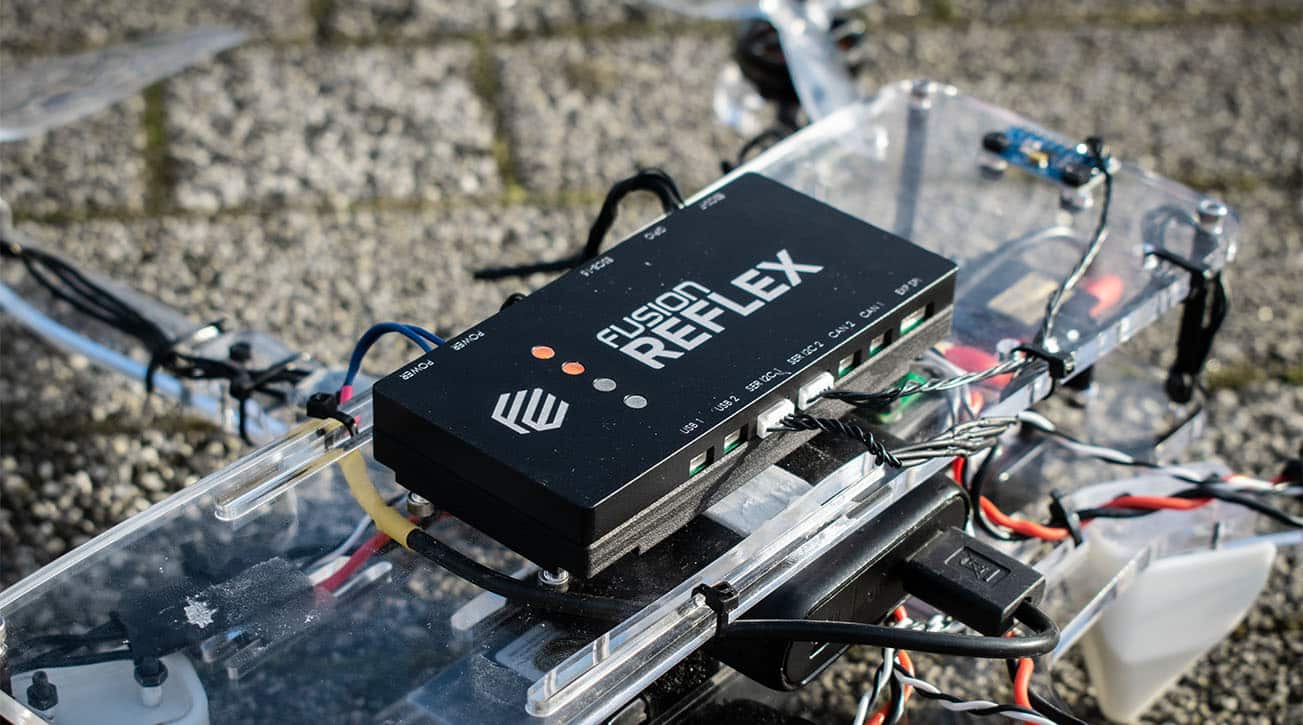 Fusion Reflex flight controller wired onto an open test drone frame.