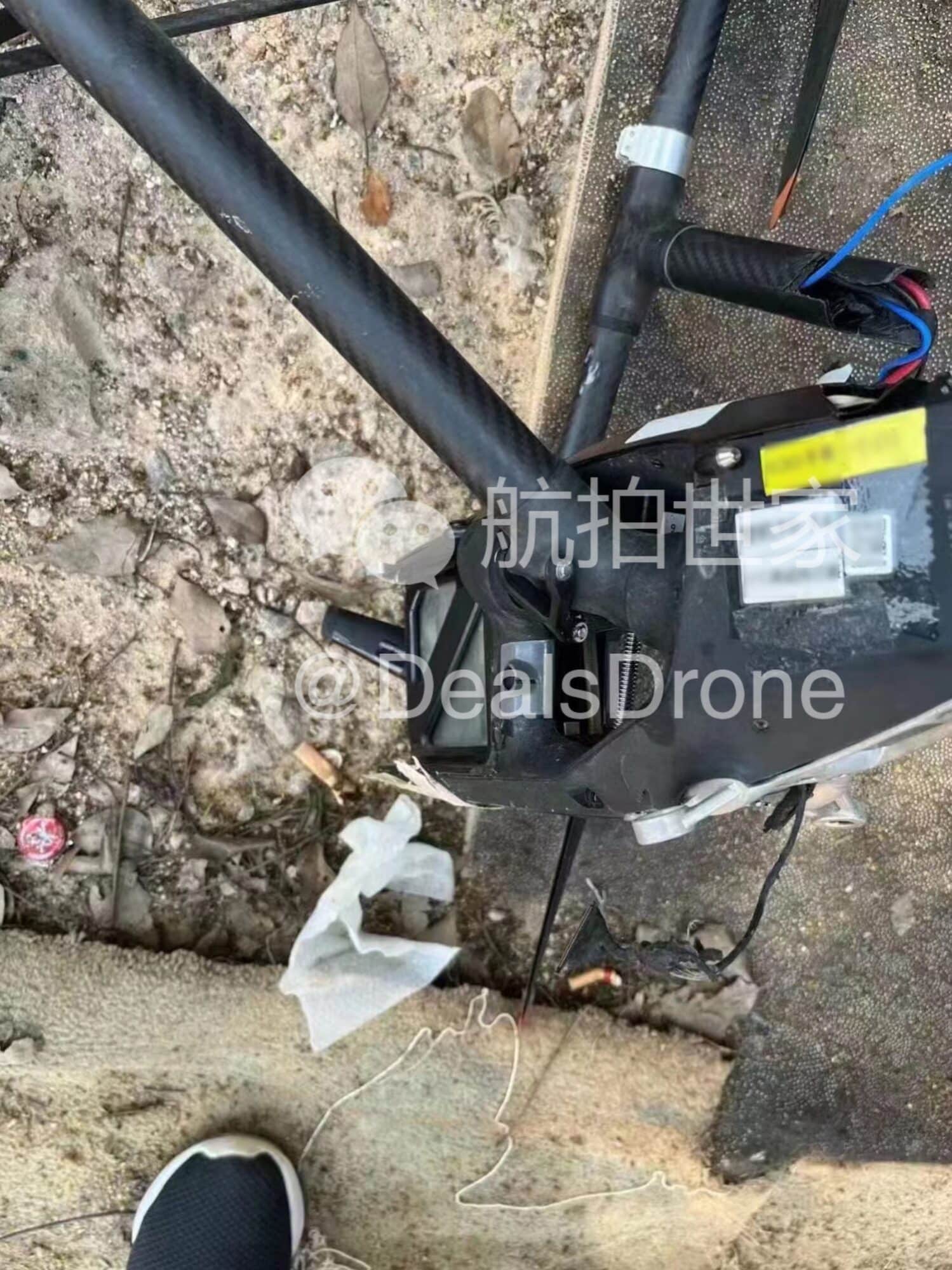 Damaged prototype drone lying on rocky ground with a snapped landing leg.