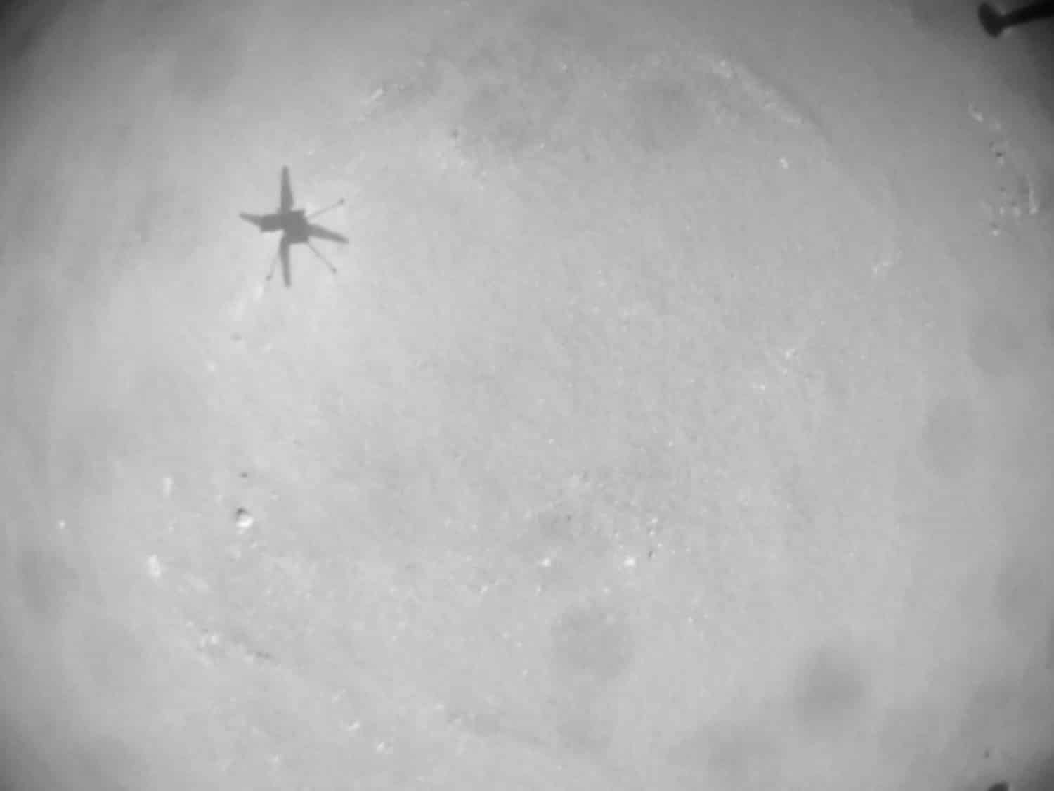 Black-and-white view of the Ingenuity helicopter shadow cast on Martian ground.