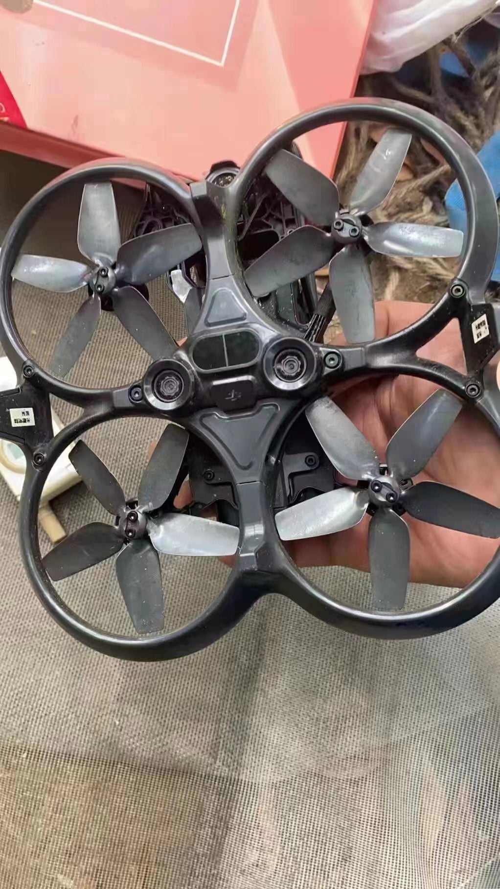A hand holds a leaked DJI Avata cinewhoop showing its four ducted propellers.