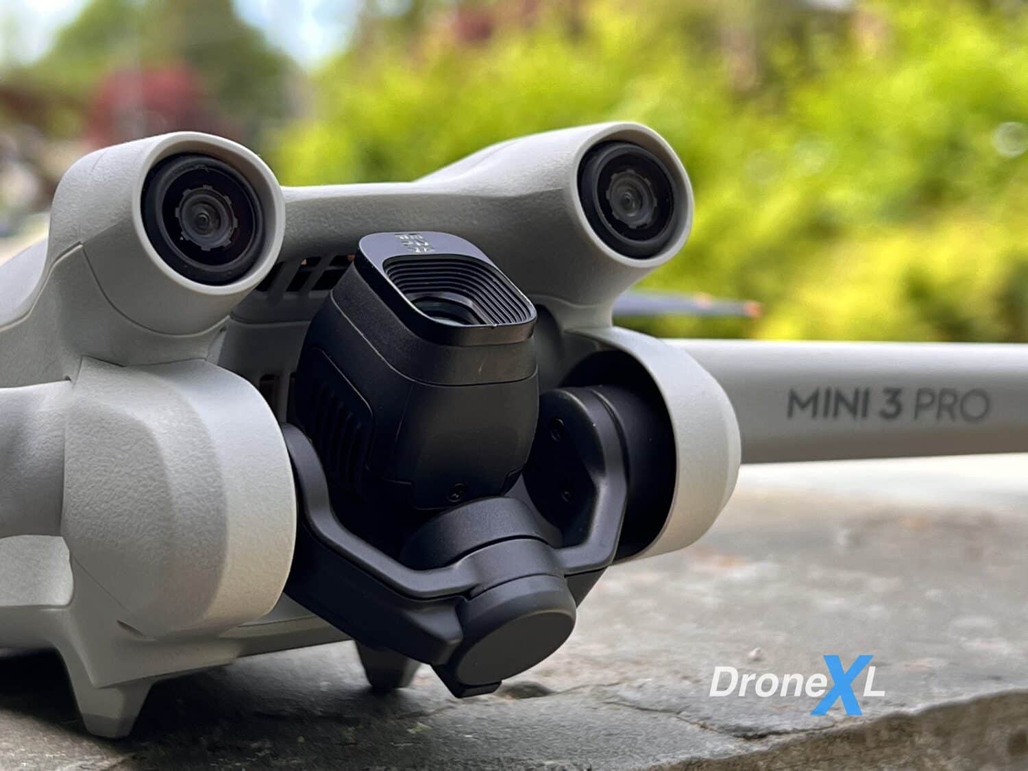 Close-up of a DJI Mini 3 Pro with its gimbal rotated for vertical shooting.