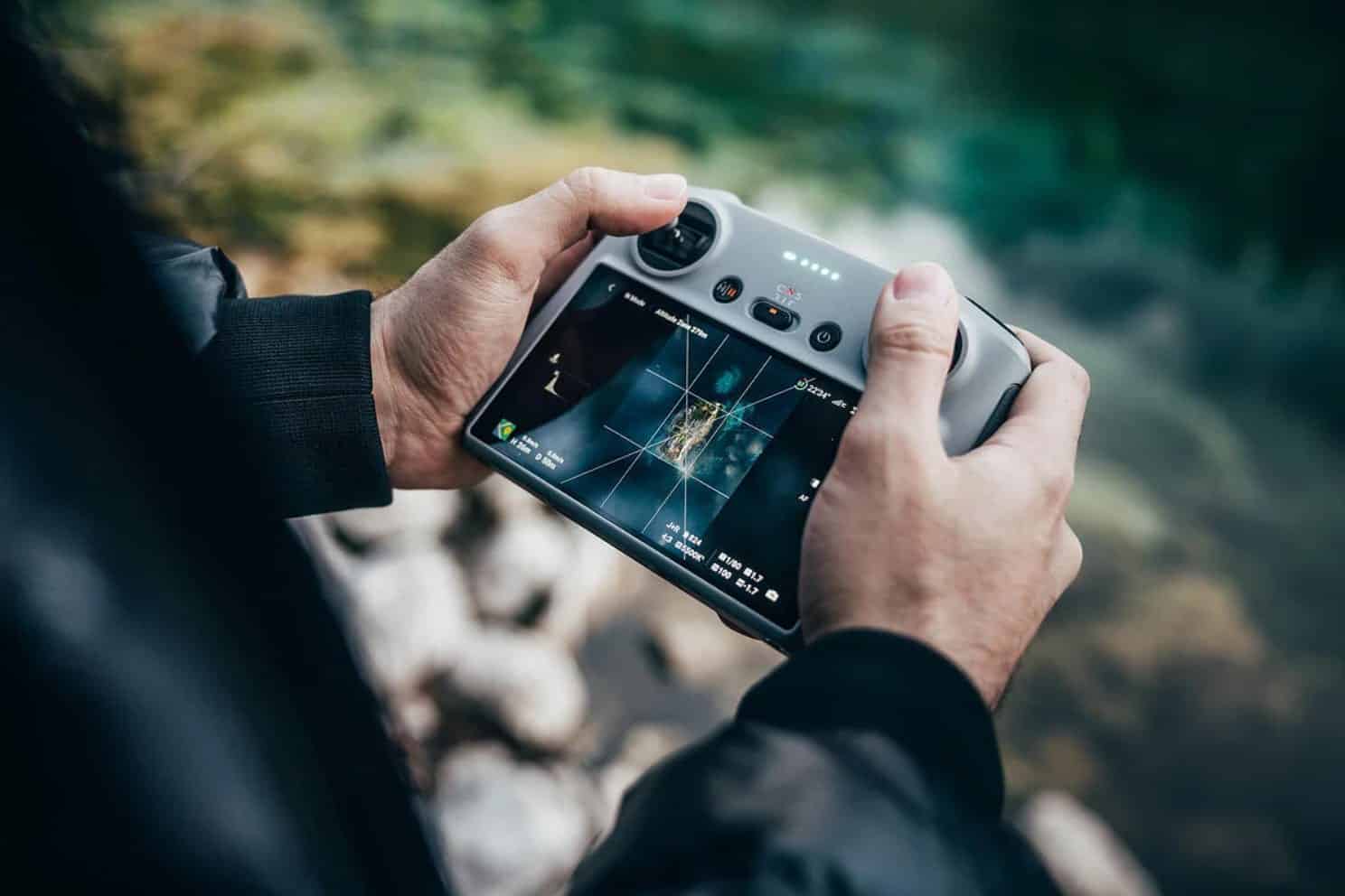 Pilot holding the Mini 3 Pro and the new DJI RC together before takeoff.