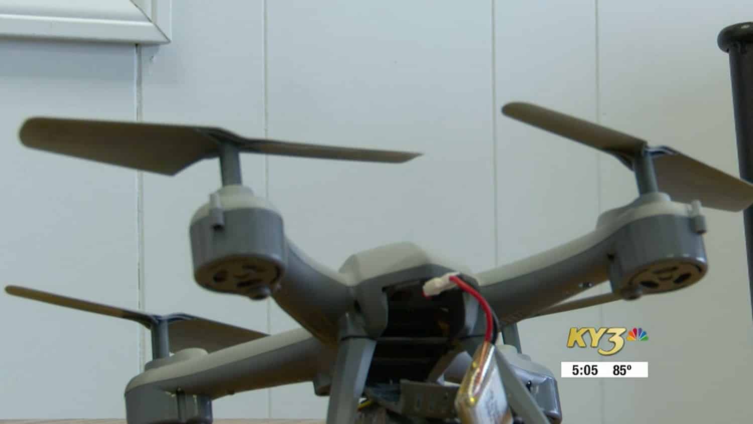 News footage of a small toy quadcopter with exposed wiring and battery.